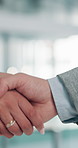 Business people, handshake or meeting with agreement for partnership, b2b or deal together at office. Closeup, employees or colleagues shaking hands with teamwork for career, greeting or introduction