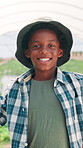 Greenhouse, happy and face of black child with farming for harvest, growth or sustainability. Smile, agriculture and portrait of African boy kid with pride for planting organic produce in environment