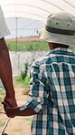Greenhouse, parent and child with holding hands for walking, agriculture and natural sustainability. Black family, kid and boy with father for bonding, conservation and connection from back in nature