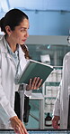 Discussion, scientist and people with tablet, lab and medical research with interactive display and online. Innovation, man and woman with tech to identify genetic mutations, collaboration or meeting