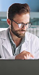 Science, man and laptop in lab with tablet, research and smile for problem solving. Medical engineer, tech and typing in office for result comparison, innovation or planning investigation on software