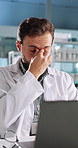 Science, headache and man in laboratory with laptop for research, development or glasses. Tired, eye strain and scientist with fatigue, online medical study and innovation in biotech engineering