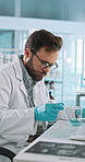 Scientist, man and solution with petri dish for biology, breakthrough or medical research. Biotech, laboratory and pipette with bacteria, DNA study and pharmaceutical RNA for pathology experiment