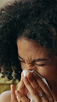 Sneeze, tissue and sick with black woman for flu season, pneumonia infection and illness on sofa. Hayfever, blowing nose and allergy with person in living room in home for recovery, disease and cold