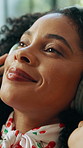 Woman, relax and headphones with music in home for streaming radio, calm podcast and album track. African person, face and audio technology for weekend break, sound subscription or listening to song