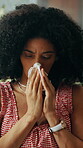 Sneeze, tissue and sick with black woman for cold season, pneumonia infection and illness on sofa. Hayfever, blowing nose and flu with person in living room in home for recovery, disease and allergy