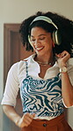 Woman, energy and dancing with headphones in home for streaming album, groovy playlist and weekend freedom. African person, happy and audio technology for feel good music and listening to radio track