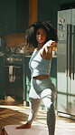 Warrior pose, yoga and exercise with woman in home, balance and calm with stretching in kitchen. Health, wellness and African yogi person for workout, fitness and holistic self care in apartment