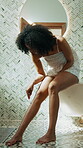 Skincare, woman and shaving legs in home for grooming routine, self care and depilation in bathroom. African person, hygiene and hair removal with razor tool for cleaning, wellness and smooth skin
