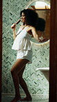 Singing, hairbrush and woman in bathroom dancing to music, playlist or radio for getting ready. Happy, energy and female person with mic for karaoke performance for fun with grooming in home.