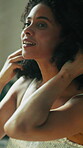 Bathroom, mirror and woman with hands for hair care, texture and growth for keratin treatment. Home, morning and female person with smile for reflection, check volume or cosmetics for curly hairstyle