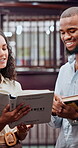 Talking, college and books with students in library for research project, education and teamwork. Study partner, learning and university research with people on campus for knowledge and reading