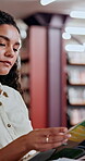 Woman, student and reading book in library for education, knowledge and information on project. Person, textbooks and study for exam preparation, university assessment and learning of academic growth