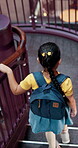 Education, stairs and walking with girl in library for child development, growth or learning. Backpack, knowledge and steps with student at school for future, information or scholarship from above