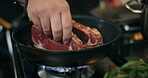 Cooking, hands and steak in frying pan in kitchen for meal preparation, enhance flavor and render beef fat. Chef, person and meat recipe in home for healthy protein, nutrition and food for wellness