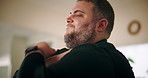 Man, stress and stretching in home with shoulder pain, muscle tension and overworked tendon. Person, discomfort and injury in arm with sprain, joint massage and orthopedic crisis with concern