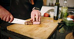 Cooking, hands and cutting meat in kitchen for dinner recipe, meal preparation and beef cuisine. Chef, person and steak protein on wood board for nutrition, healthy dining and food for lunch in home