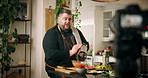 Man, chef and talk with video, recording and grater in kitchen with organic produce for cooking show in home. Person, tutorial and influencer with content creation, chat and carrots for meal in house