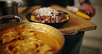 Person, chef and steak with pasta in kitchen for food, diet and meal preparation. Nutrition, meat cuisine and dinner recipe with plate presentation for dining aesthetic, wellness and catering service