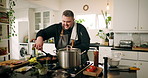Cooking, home and man in kitchen, smile and food with healthy ingredients, recipe and gourmet. Person, happy and professional with nutrition, diet and lunch with culinary skills, cuisine and wellness