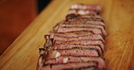 Cook, beef slices and serving with food for catering, hospitality or meat cuisine on wooden board. Empty, closeup and health with dinner, nutrition or culinary recipe for gourmet dish in kitchen