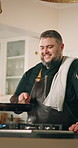 Man, flambe and kitchen with chef for cooking, fire or hospitality in home with frying pan. Male person, culinary art for gourmet cuisine, nutrition or technique for meal preparation, dinner and food