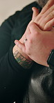 Man, hands and wrist injury with massage for pain, overworked tendon and sprain in industry. Tattoo artist, closeup and joint strain in studio with carpal tunnel, muscle burnout and discomfort