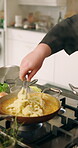 Hands, man and cooking pasta in frying pan for gourmet meal, food preparation and healthy recipe. Closeup, chef and cuisine in sauce with organic ingredients, homemade dinner or culinary dish in home