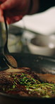 Recipe, hands and person with steak in frying pan for meal preparation, healthy ingredients and sear meat cuisine. Closeup, chef and cooking beef food with thyme for nutrition, protein diet or dinner