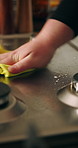 Cleaning, cloth and hands with stove in kitchen for hygiene, housekeeping and disinfection. Home, house and closeup of person with sponge on oven wipe for dust, sanitation and detergent for cooking