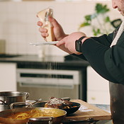 Chef, cheese and man in kitchen for cooking dinner, cuisine and meal ...