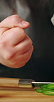 Hands, knife and cutting board with green pepper for cooking, organic ingredients and carpal tunnel with burnout. Person, wrist pain and vegetables with fatigue, recipe or nutrition with food in home