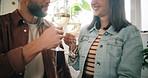 Couple, wine glass and hands with toast in kitchen, home and bonding with love, celebration and goals. People, cheers and achievement with smile for alcohol, drink and anniversary at apartment