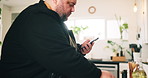 Cooking, phone and seasoning with man in kitchen of home for preparation of meal or supper. Food, ingredients and recipe with chef at counter in apartment for diet, healthy eating or nutrition