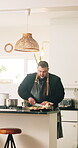 Cooking, cutting and food with man in kitchen of home for cuisine or meal preparation. Culinary, ingredients and recipe with chef person at counter in apartment for diet, health or nutrition