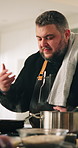 Man, chef and cooking with smell on stove in kitchen for meal, hospitality or catering service at home. Male person, pan or stiring mixture with aroma, ingredients or flavor for dinner or cuisine