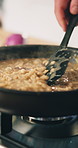 Cooking, stove and hands of chef with pan for culinary skills, gourmet recipe and meal prep for dinner. Catering, restaurant and person with ingredients for cuisine, mushroom risotto and nutrition