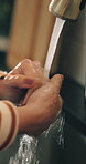 Person, hands and washing with water for hygiene, disinfection or rinse in kitchen sink at home. Closeup, tap or faucet with aqua, liquid or protection for dirt, bacteria or germ removal at house