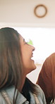 Couple, cooking and smile with conversation in kitchen, laugh and teaching with apron, nutrition and dinner. Man, woman and support with advice, bonding and help with talking for meal prep in home