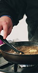 Cooking, stove and man with food in pan for culinary skills, gourmet recipe and meal prep for dinner. Catering, restaurant and chef with ingredients for cuisine, aroma and nutrition in kitchen