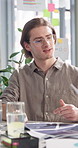 Man, talking and documents for meeting at startup, review and planning for proposal at tech company. Person, paperwork and check stats with graphs, insight and project management in office at agency