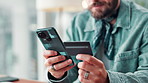 Business, hands and man with smartphone, credit card and online shopping with transactions. Closeup, person and employee in workplace, cellphone and payment with ecommerce and digital app for banking