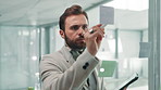 Businessman, writing and planning with tablet for brainstorming project or tasks on glass board. Man, employee or planner with technology, ideas or sticky notes for mindmap, work schedule or reminder