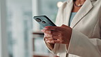 Black woman, hands and typing with phone for communication, chatting or texting at office. Female person, employee or user with mobile smartphone for online app, social media or network at workplace