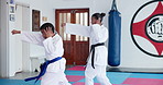 Kids, karate and students training in dojo for fight, fitness and learning self defense in class. Boy, girl and children practice martial arts for skill, lesson and workout with energy to exercise