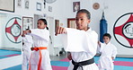 Group, karate and kids training in dojo for fight, fitness and learning self defense in class for sports. Students, children and practice martial arts for lesson, workout and punch for exercise