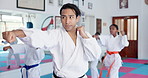 Children, learning karate and training with instructor for fight, fitness or self defense class. Students, teacher and people practice martial arts for kick, punch or kids exercise for lesson in dojo