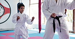 Child, karate and sensei with fighting kata for self defense training, taekwondo or martial arts. Teacher, kid and learning with aikido master or mentor for discipline, technique or lesson in dojo
