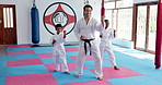 Teaching karate, children and training with instructor for fight, fitness lesson or self defense class. Students, teacher and practice martial arts for exercise, learning or coaching kids in dojo