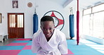 Bow, martial arts and self defense with face of boy in dojo for start of class, fight or lesson. Development, karate and smile of combat student in gym for exercise, fitness or sports training